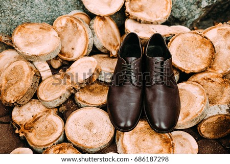 Brown shoes of groom on a wooden rustic background. Men's accessories. Top view