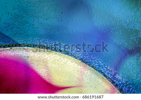 Bubbles, water droplets on the glass, Watercolor paint dissolves in water, Colored abstractions