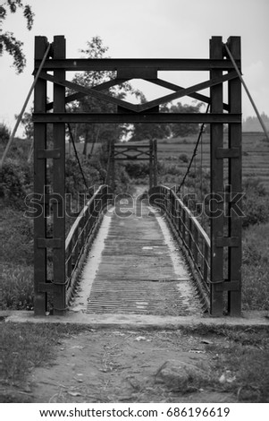 black and white picture iron bridge in the countryside use across the fields and villages.