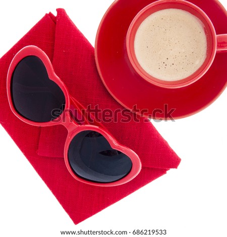 red heart shaped glasses with cup of coffee and napkin