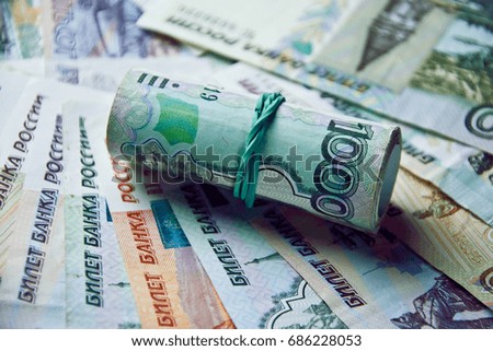 bundle of banknotes stretched with an elastic band on the background of money