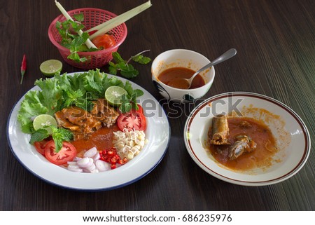 Spicy fish Canned Sardines Salad and ingredient cooking on dark background Thai food  /  select focus and food for stock image, dim light 
