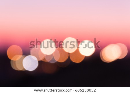 Abstract pink background in the form of blurry lights on the horizon.