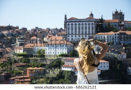 Young woman photographing cityscape of Porto, Portugal