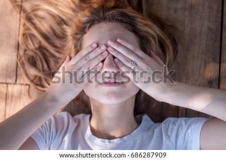 The girl closed her eyes with hands Royalty-Free Stock Photo #686287909