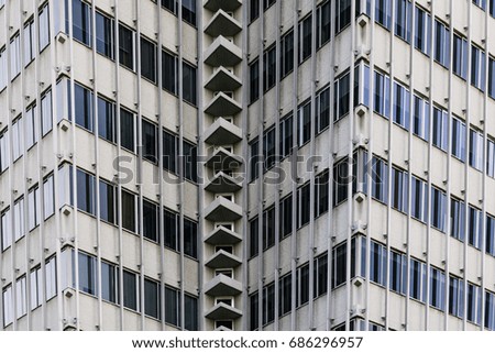 Facade and windows of modern urban office tower close up view