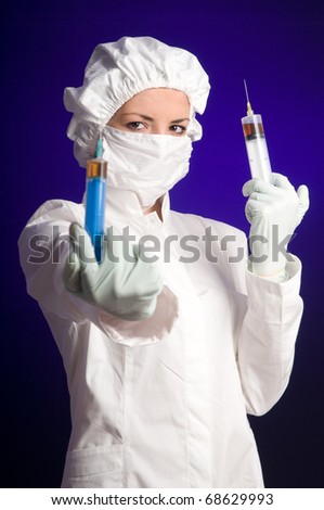 Nurse wearning medical uniform and holding a syringe