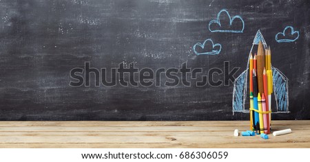 Back to school concept with rocket made from pencils over chalkboard background Royalty-Free Stock Photo #686306059