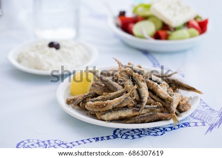 Fried anchovies, gavros in greek taverna Royalty-Free Stock Photo #686307619