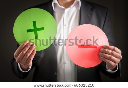Pros and cons concept. Business man with cardboard plus and minus symbol signs. Royalty-Free Stock Photo #686323210