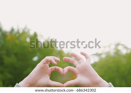 Child hands with a heart shaped. Healthy, happy childhood concept.
