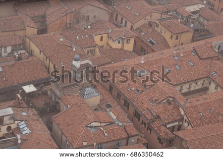 Typical red roofs of Bologna in a foggy day. View from a window of Asinelli Tower. Emilia Romagna , Italy.