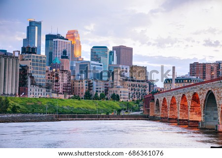 Downtown Minneapolis, Minnesota at night time as seen from the famous stone arch bridge Royalty-Free Stock Photo #686361076