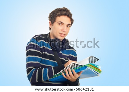 Student guy with headphones writing in notebooks over blue background