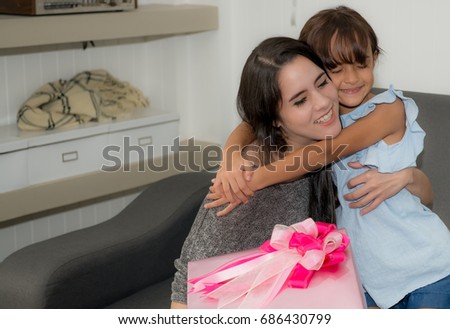 Girls give gifts to mothers,Little Asian girl giving gift for mother and kissing on mother's cheek,Happy family with christmas gift,Mother day.