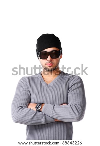 Cool Latino Man Dressed In Grey Pullover, Trendy Sunglasses And Beanie Hat, unshaven guy 
with short bristles on the face. Royalty-Free Stock Photo #68643226