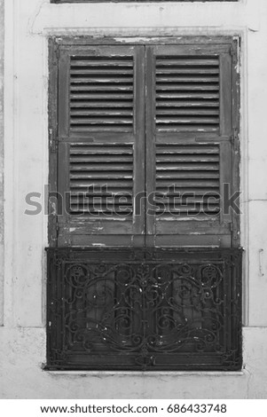 Building with traditional maltese window in historical part of Valletta. Black and white picture
