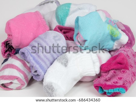 Pile of sorted children's socks, ready to put away Royalty-Free Stock Photo #686434360