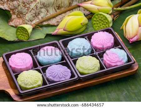 Traditional Chinese mid autumn festival food. Snowy skin mooncakes. The Chinese words on the mooncakes is green tea with red bean paste, noble delight and lotus paste