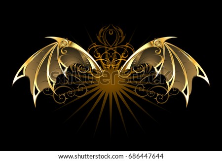 Steampunk mechanical dragon wings of gold and brass on black background.