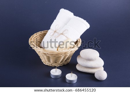 Two white canvas rolls folded in a basket. Dark background.Still life.