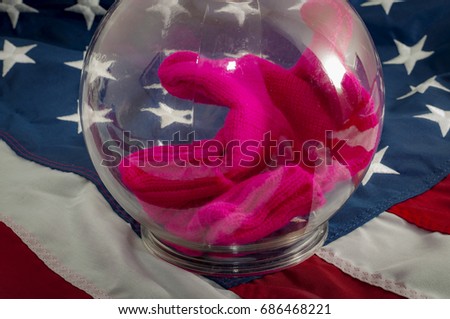 Social media filter bubble and isolation based on tribal politics concept with a pussy hat enclosed in a clear plastic bubble that distorts colors and shapes