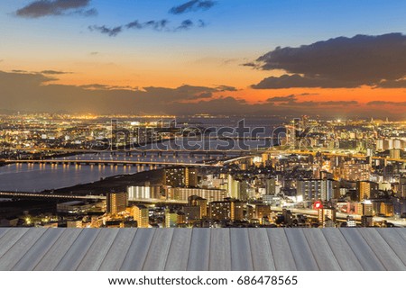 Opening wooden floor, aerial view Osaka city downtown after sunset skyline, Japan 