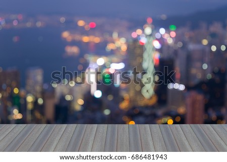 Opening wooden floor, Twilight blurred bokeh light Hong Kong city downtown, abstract background