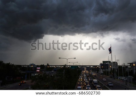 Dark clouds and rainstorms are falling in the city. A large rainstorm makes traveling in Bangkok difficult. Black clouds are brewing in Bangkok