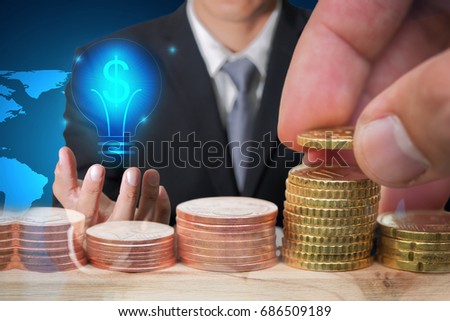 Double exposure of Euro Coin stacks on table, businessman hand hold, glowing blue dollar sign and bulb technology icon as business, 