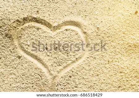 Heart drawn in the sand. Shapes in the sand. Sandy beach. The symbols of love. The summer mood.