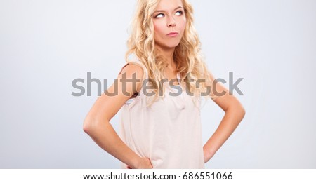 Young woman standing, isolated on gray background