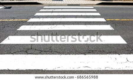 pedestrian zebra crosswalk with asphalt road