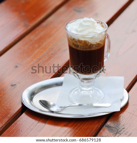 austrian coffee with cream on red cafe table