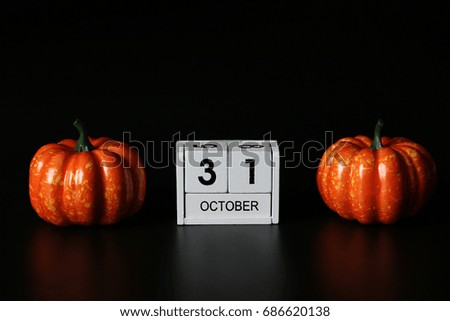 31 October Wooden calendar and pumpkin for Halloween day on background.Copy space,minimal style