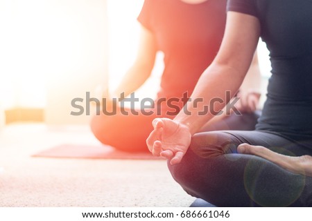 Class of yoga with meditate hands of Asia woman doing meditation in sunrise and lens flair effect.Healthcare, lifestyle concept.National Physical Fitness and Sports Month.National Yoga Awareness Month Royalty-Free Stock Photo #686661046