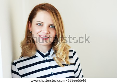 beautiful woman with blond hair in white shirt Royalty-Free Stock Photo #686665546