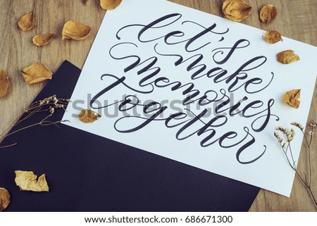 Let's make memories together, written in calligraphy style on white paper