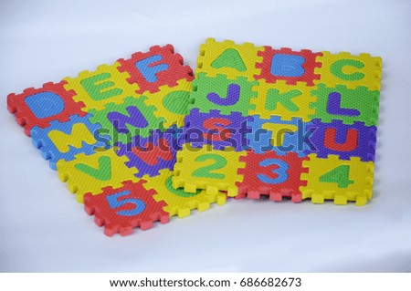 Rubber mat with colorful alphabet design isolated on white background.  
