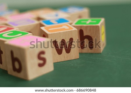wood alphabet bricks on table.  Early learning. stripe background. Developing toys