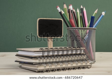 back to school template with a chalk board and pencils on table