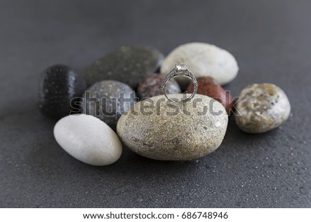 Natural stones and rings on black background