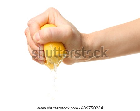 Female hand squeezing half of lemon on white background Royalty-Free Stock Photo #686750284