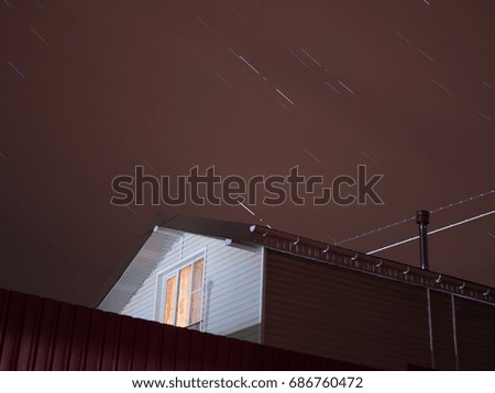 Star trails with a small house. Moscow region, Domodedovo district