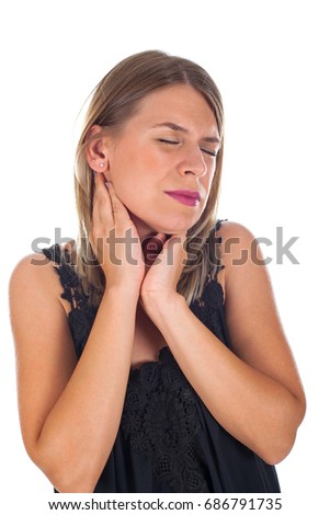  Picture of young woman having sore throat holding her neck, checking the inflamed glands - isolated background