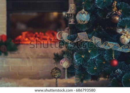 Beautiful holiday decorated room with Christmas tree, fireplace and  blanket. Cozy winter scene. Feast  interior with lights.