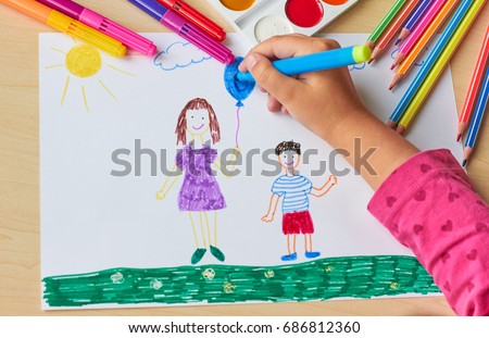 The child draws a picture with pencils
