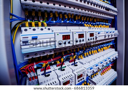 Voltage switchboard with circuit breakers. Electrical background Royalty-Free Stock Photo #686813359