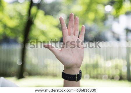 Man hand , five , isolated on garden background