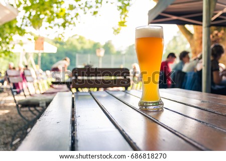 German Beer 0,5 Liter on Wooden Table Biergarten Traditional Culture Beautiful Day Royalty-Free Stock Photo #686818270